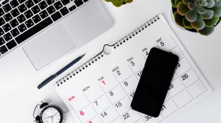 Calendar page close up on wooden office desk